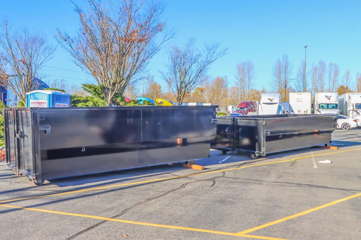 Professional dumpster rental service with roll-off container on residential driveway in Snellville